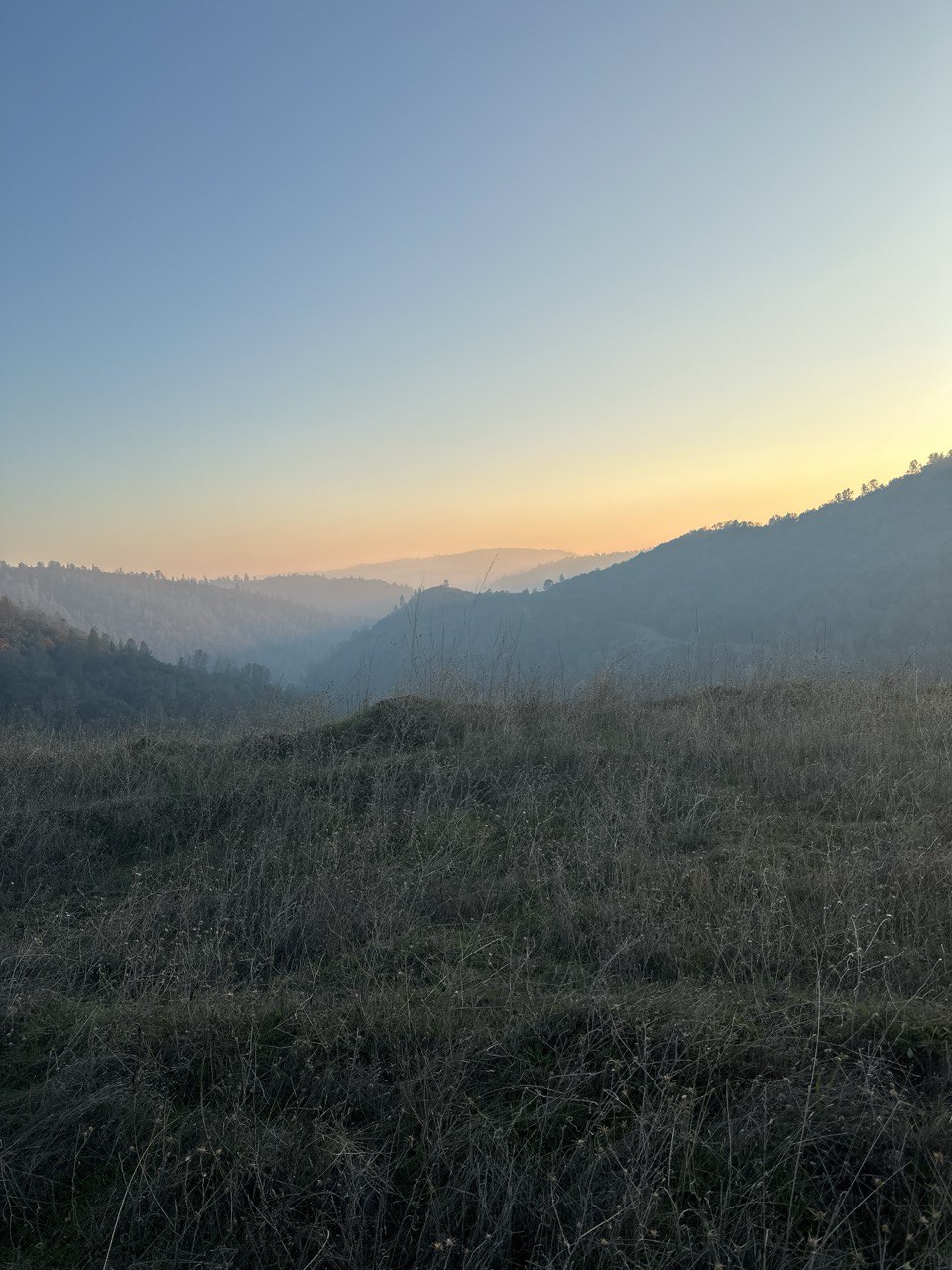 The setting sun on the foothills